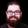 A picture of a man with a beard and glasses